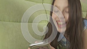 Beautiful teenage girl having fun communicating on smartphone stock footage video