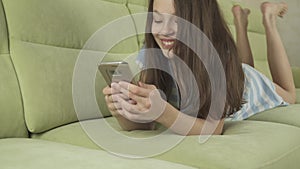 Beautiful teenage girl having fun communicating on smartphone stock footage video