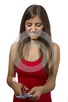Beautiful teenage girl portrait excited cutting credit card