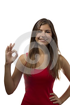 Beautiful teenage girl portrait gesturing ok sign