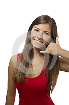 Beautiful teenage girl portrait gesturing telephone sign