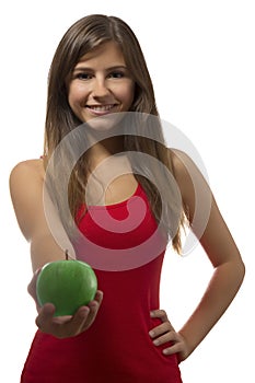 Beautiful teenage girl portrait offering green one apple