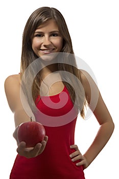 Beautiful teenage girl portrait offering one red apple