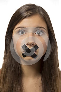 Beautiful teenage girl portrait with taped mouth