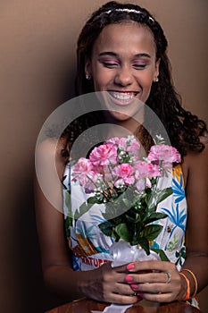 Beautiful teenage girl, sitting, with bouquet of flowers