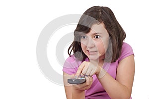 Beautiful teenage girl with tv remote control in her hands