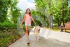 Beautiful teenage girl walking her dogs