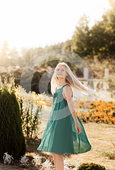 Beautiful teenage girl walking in the park in the summer