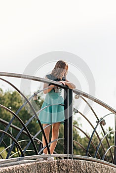 Beautiful teenage girl walking in the park in the summer