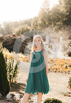 Beautiful teenage girl walking in the park in the summer