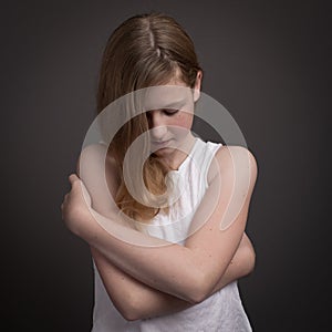 Beautiful Teenage Girl In White Dress Embracing Herself