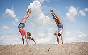 Beautiful teenage girls dancing and jumping on the beach