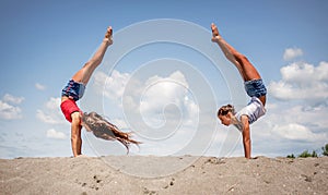 Beautiful teenage girls dancing and jumping on the beach