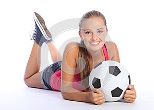 Beautiful teenage soccer girl lying on floor