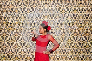 Beautiful teenage woman dancing flamenco doing different flamenco dance postures on a background of typical arabic tiles. She