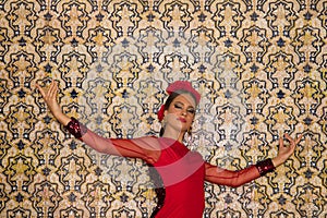 Beautiful teenage woman dancing flamenco doing different flamenco dance postures on a background of typical arabic tiles. She