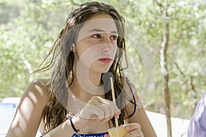 Beautiful teenager is drinking a cold soft-drink