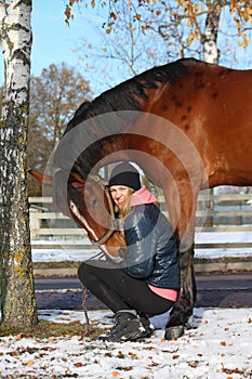 Beautiful teenager girl and bay horse portrait in autumn