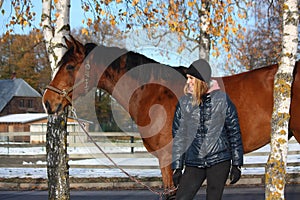 Beautiful teenager girl and bay horse portrait in autumn