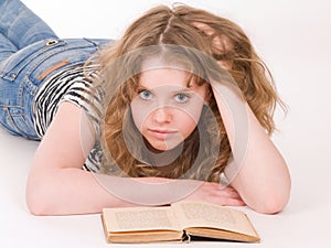 Beautiful teenager girl reading a book