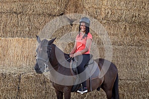 Beautiful teenager with his horse learning to ride