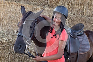 Beautiful teenager with his horse learning to ride