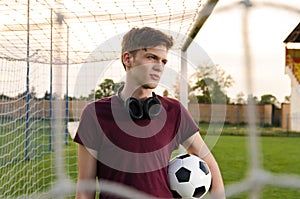 Beautiful teenager holding soccer ball