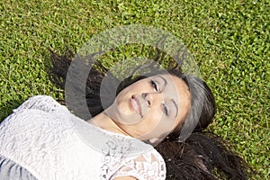 Beautiful Teenager Lying On The Grass