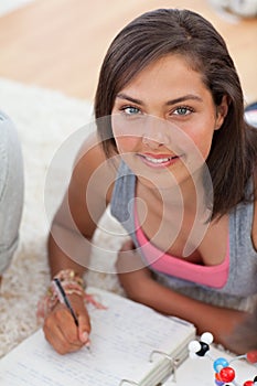 Beautiful teenager studying on the floor