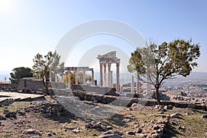 Beautiful temple of Trajan autumn view with white marble columns with blue sky and valley background, ancient city Pergamon, Turke