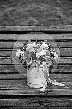 Beautiful tender bouquet of flowers in pink box on wooden background