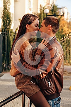 Beautiful tender couple posing in autumn park in elegant clothes