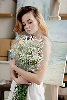 beautiful tender girl holding white flowers in art