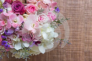 Beautiful tender wedding bouquet of cream roses and eustoma flowers in hands of the bride