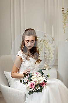 Beautiful tender young bride with flower bouquet