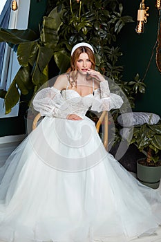 Beautiful tender young woman brunette bride in a luxury white wedding dress lace chiffon Summer happiness awaits the groom