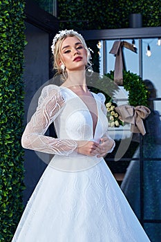 Beautiful tender young woman sexy blonde hair bride in a luxury white wedding dress lace chiffon Summer happiness awaits the groom