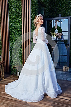 Beautiful tender young woman sexy blonde hair bride in a luxury white wedding dress lace chiffon Summer happiness awaits the groom