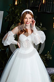 Beautiful tender young woman sexy brunette bride in a luxury white wedding dress lace chiffon Summer happiness awaits the groom