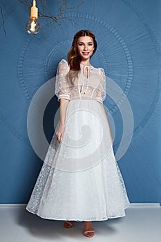 Beautiful tender young woman sexy brunette bride in a luxury white wedding dress lace chiffon Summer happiness awaits the groom