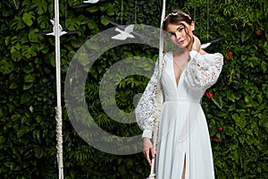 Beautiful tender young woman sexy brunette bride in a luxury white wedding dress lace chiffon Summer happiness awaits the groom