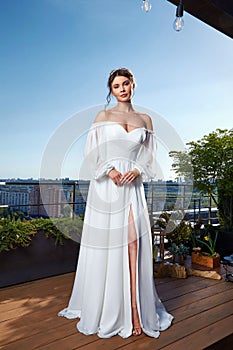 Beautiful tender young woman sexy brunette bride in a luxury white wedding dress lace chiffon Summer happiness awaits the groom