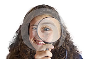 Beautiful tennager girl looking through a magnifying glass