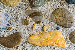 Beautiful texture background of diverse colored stones in different sizes with flint rocks in between