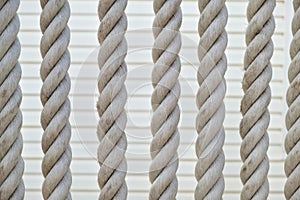 Beautiful texture of vintage rope background. rope string vertical hang in front of wall
