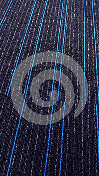 Beautiful textured carpet with blue lines.