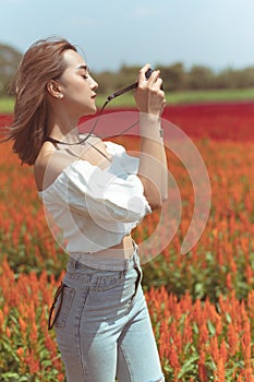 Beautiful Thai lady is walking around and taking photos in a beautiful flower garden.