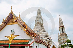 Beautiful Thai style temple roof with a view of pagoda at Wat Arun. Bangkok, Thailand.