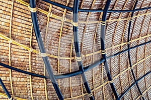 Beautiful thatched roof surface detail of mixed materials pattern structure by weave pile straw with steel bars.