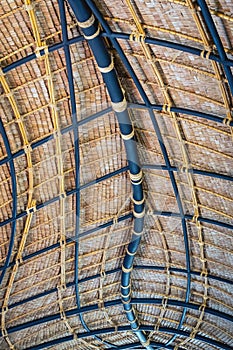 Beautiful thatched roof surface detail of mixed materials pattern structure by weave pile straw with steel bars.